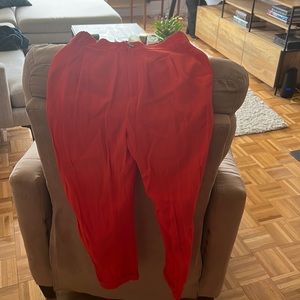 Anthropology high waisted orange/salmon color pants that are folded at bottom